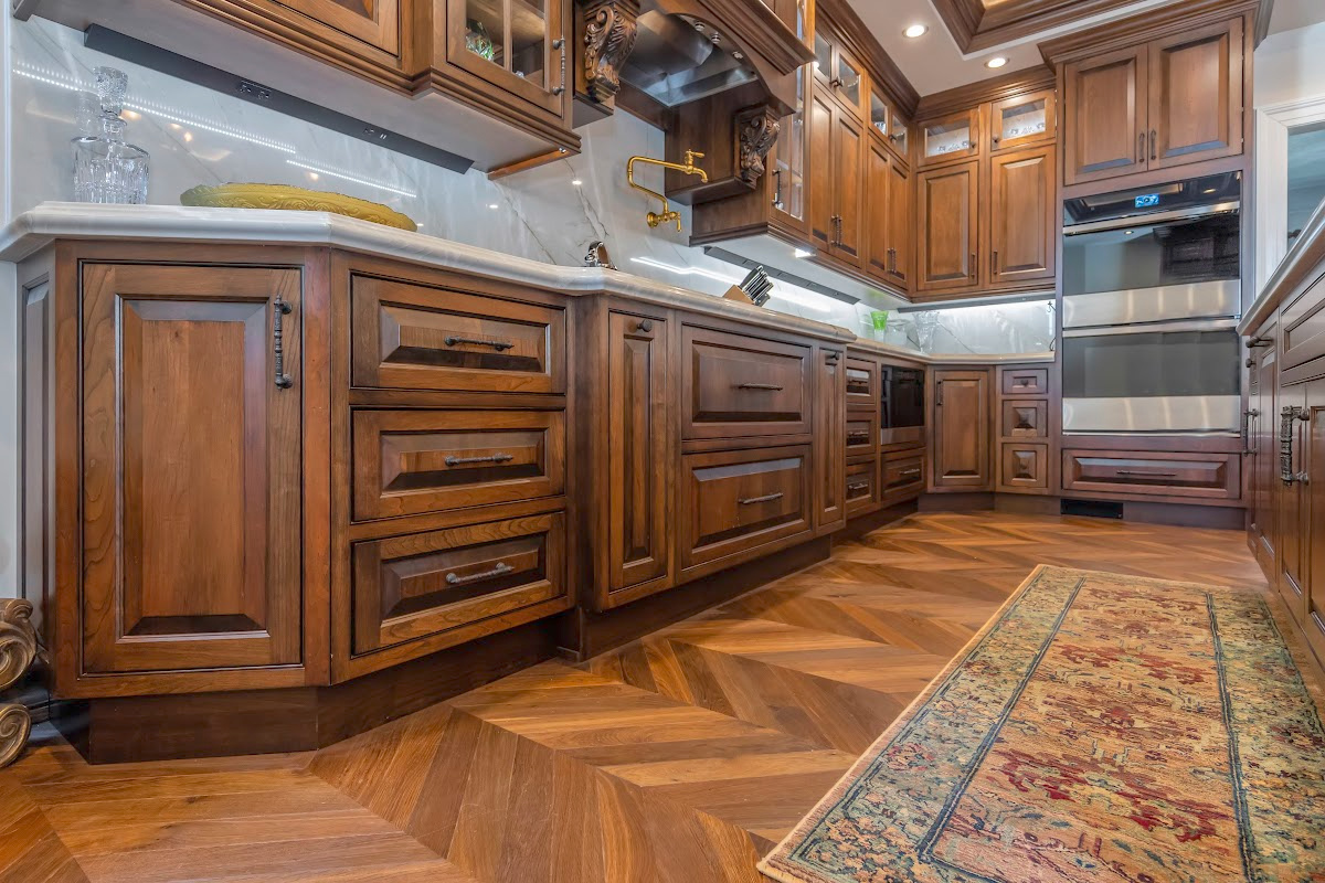 Traditional cherry kitchen cabinets with decorative elements.