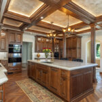 Traditional cherry kitchen cabinets with decorative elements.