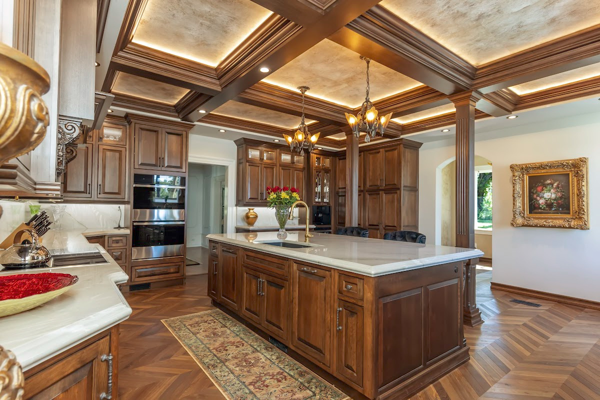 Traditional cherry kitchen cabinets with decorative elements.