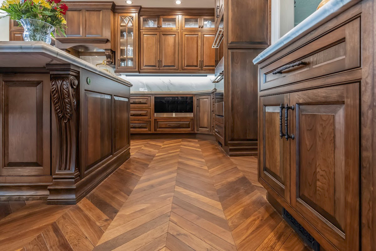 Traditional cherry kitchen cabinets with decorative elements.