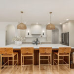 White painted kitchen cabinets and stained island.