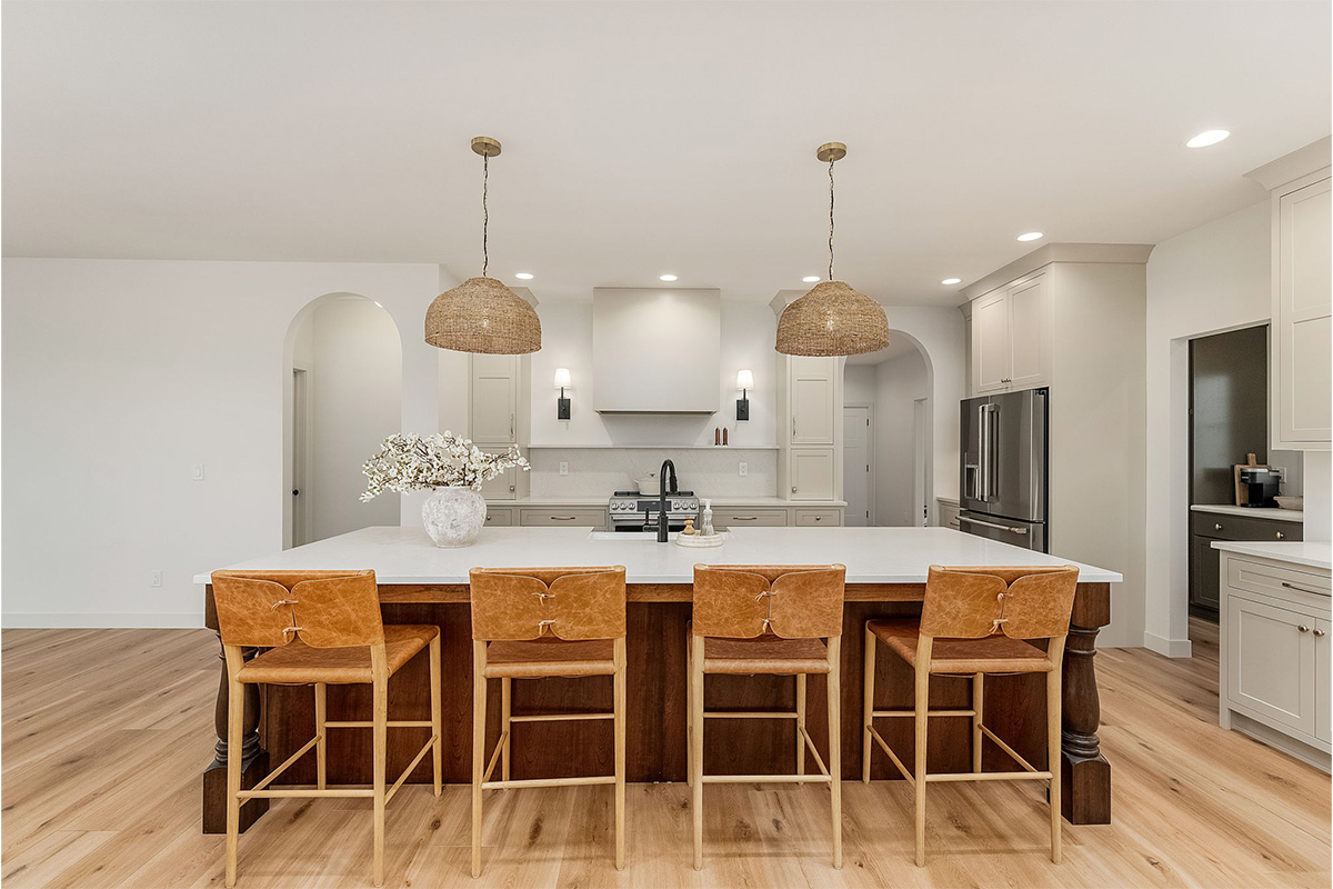 White painted kitchen cabinets and stained island.