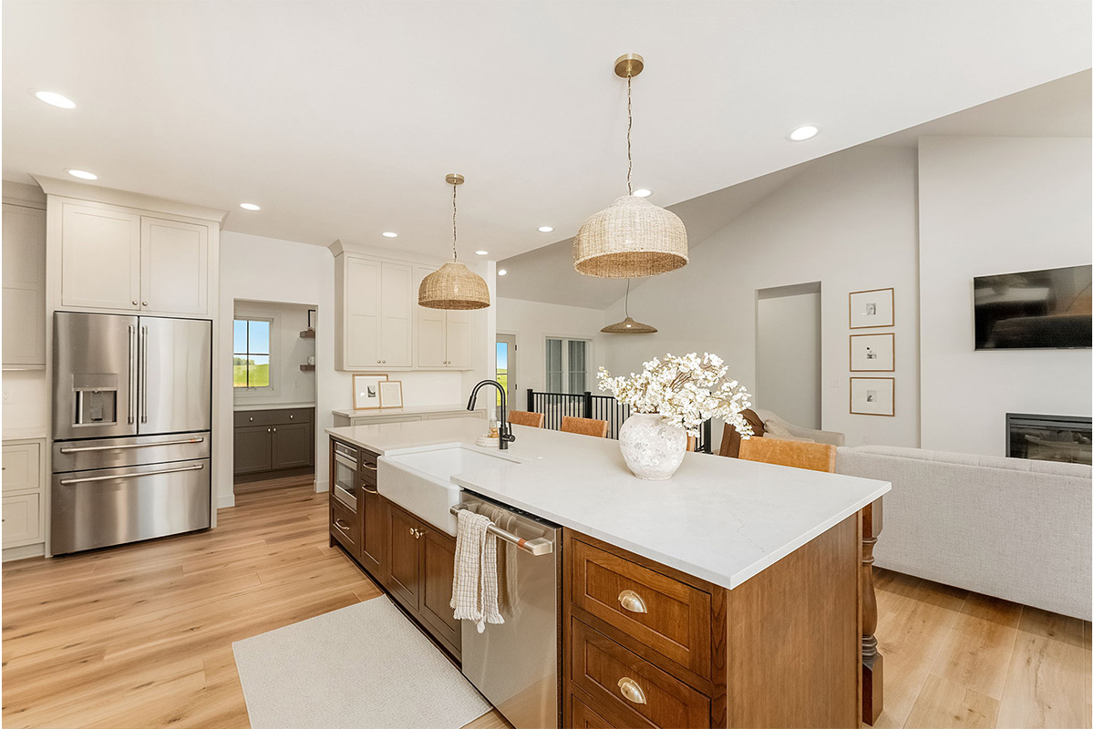 White painted kitchen cabinets and stained island.