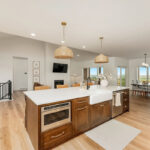 White painted kitchen cabinets and stained island.