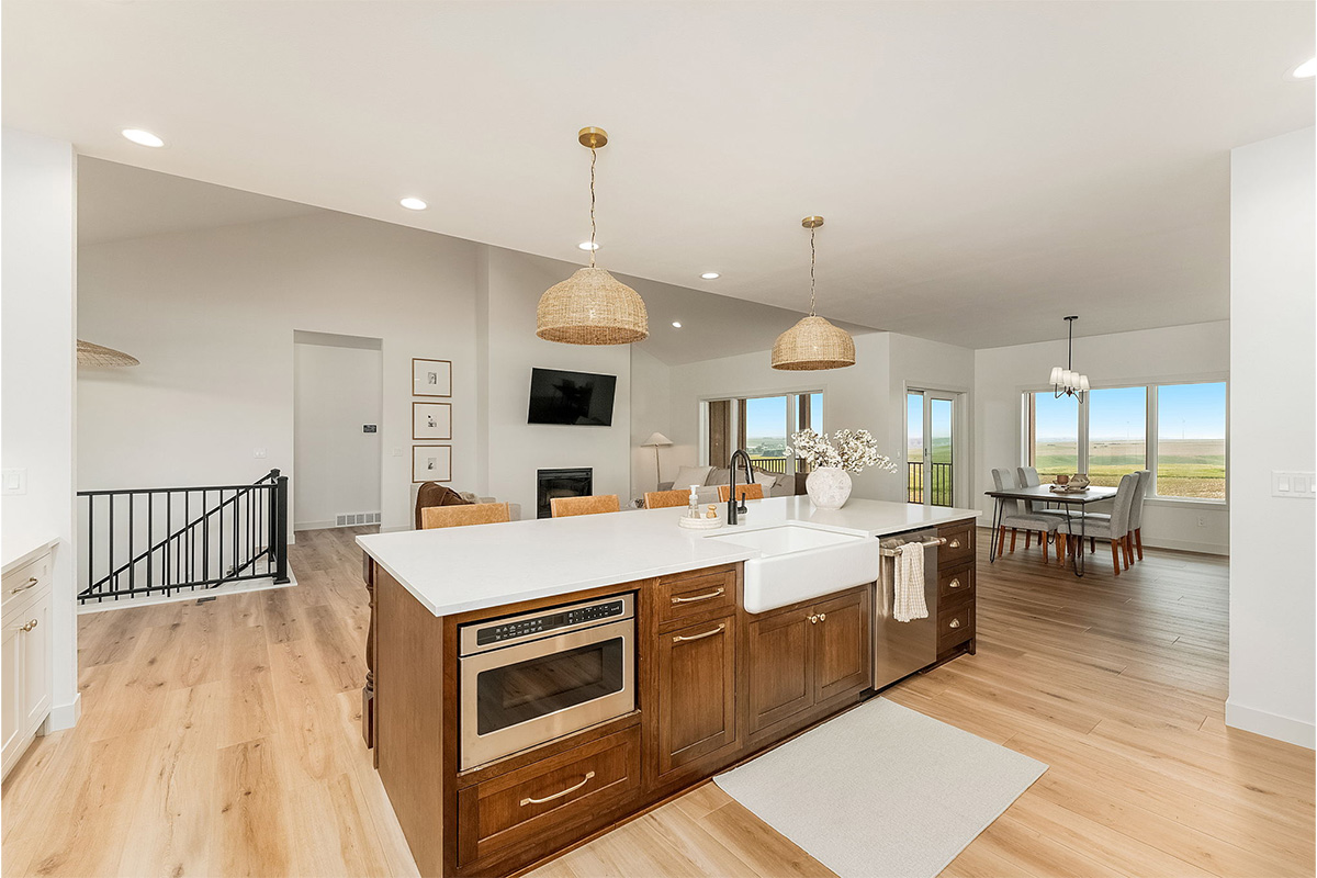 White painted kitchen cabinets and stained island.