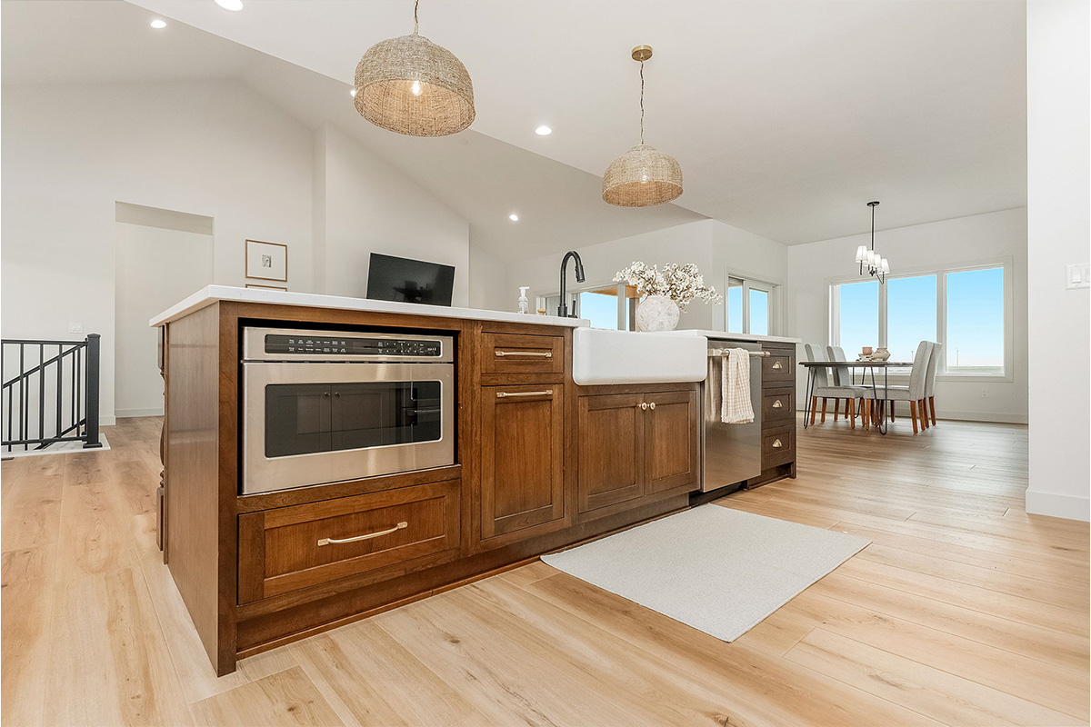 White painted kitchen cabinets and stained island.