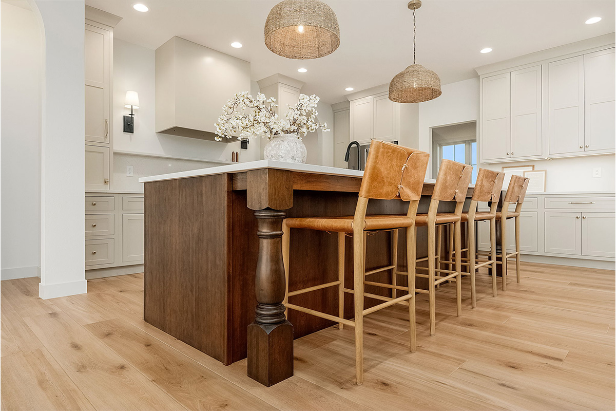 White painted kitchen cabinets and stained island.