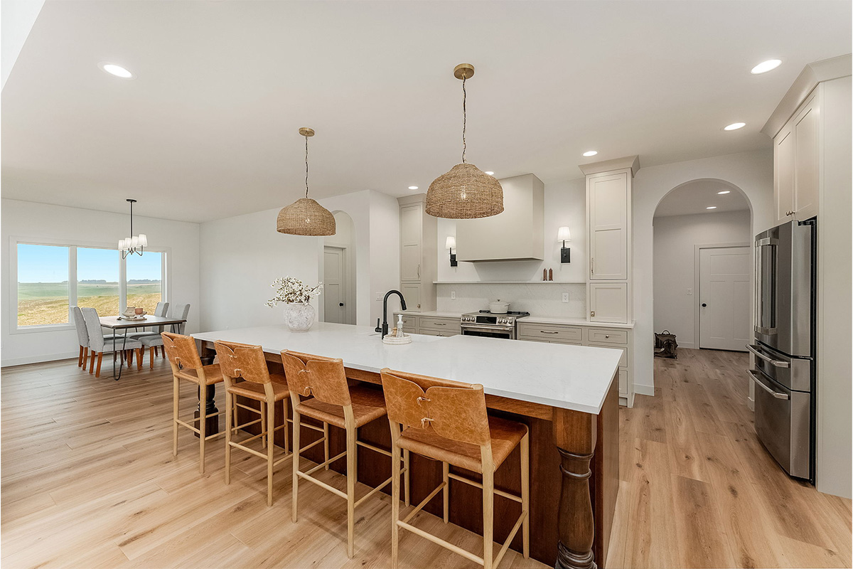 White painted kitchen cabinets and stained island.