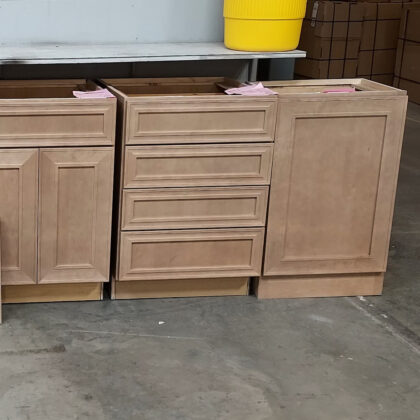 Base cabinets in a warehouse setting finished with Sable stain on maple wood.