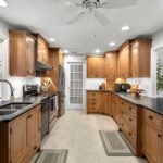 Stained cabinets in a narrow kitchen. Cabinets made with quartersawn white oak stained with Buff finish.