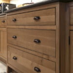 Stained cabinets in a narrow kitchen. Cabinets made with quartersawn white oak stained with Buff finish.