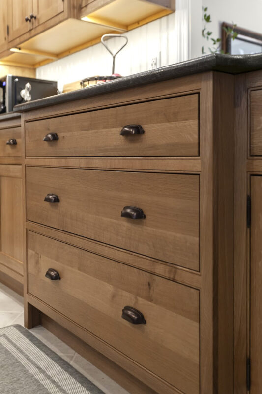 Stained cabinets in a narrow kitchen. Cabinets made with quartersawn white oak stained with Buff finish.