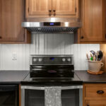 Stained cabinets in a narrow kitchen. Cabinets made with quartersawn white oak stained with Buff finish.