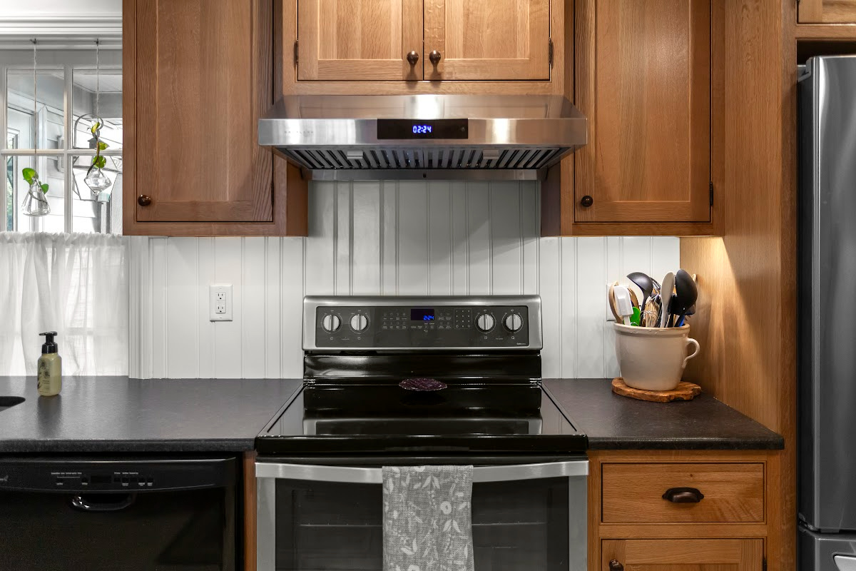 Stained cabinets in a narrow kitchen. Cabinets made with quartersawn white oak stained with Buff finish.