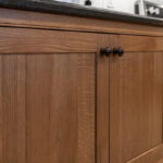 Stained cabinets in a narrow kitchen. Cabinets made with quartersawn white oak stained with Buff finish.