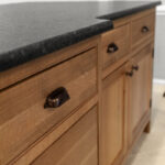 Stained cabinets in a narrow kitchen. Cabinets made with quartersawn white oak stained with Buff finish.