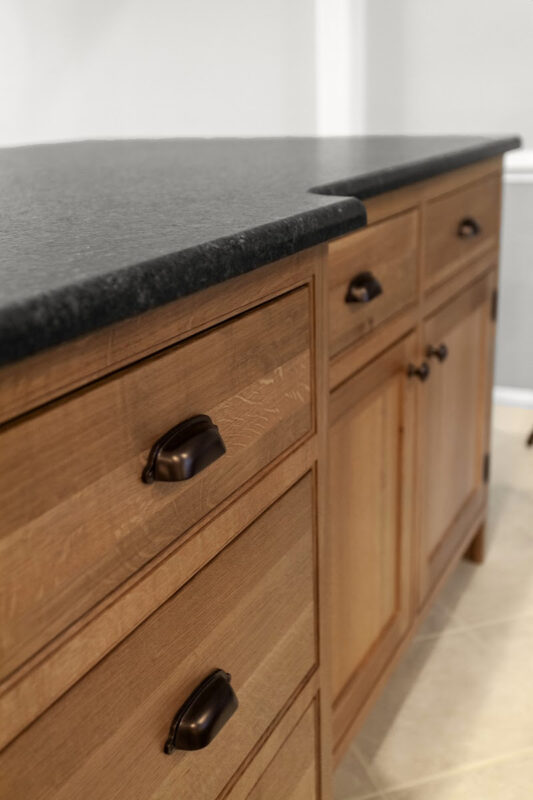 Stained cabinets in a narrow kitchen. Cabinets made with quartersawn white oak stained with Buff finish.