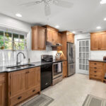 Stained cabinets in a narrow kitchen. Cabinets made with quartersawn white oak stained with Buff finish.