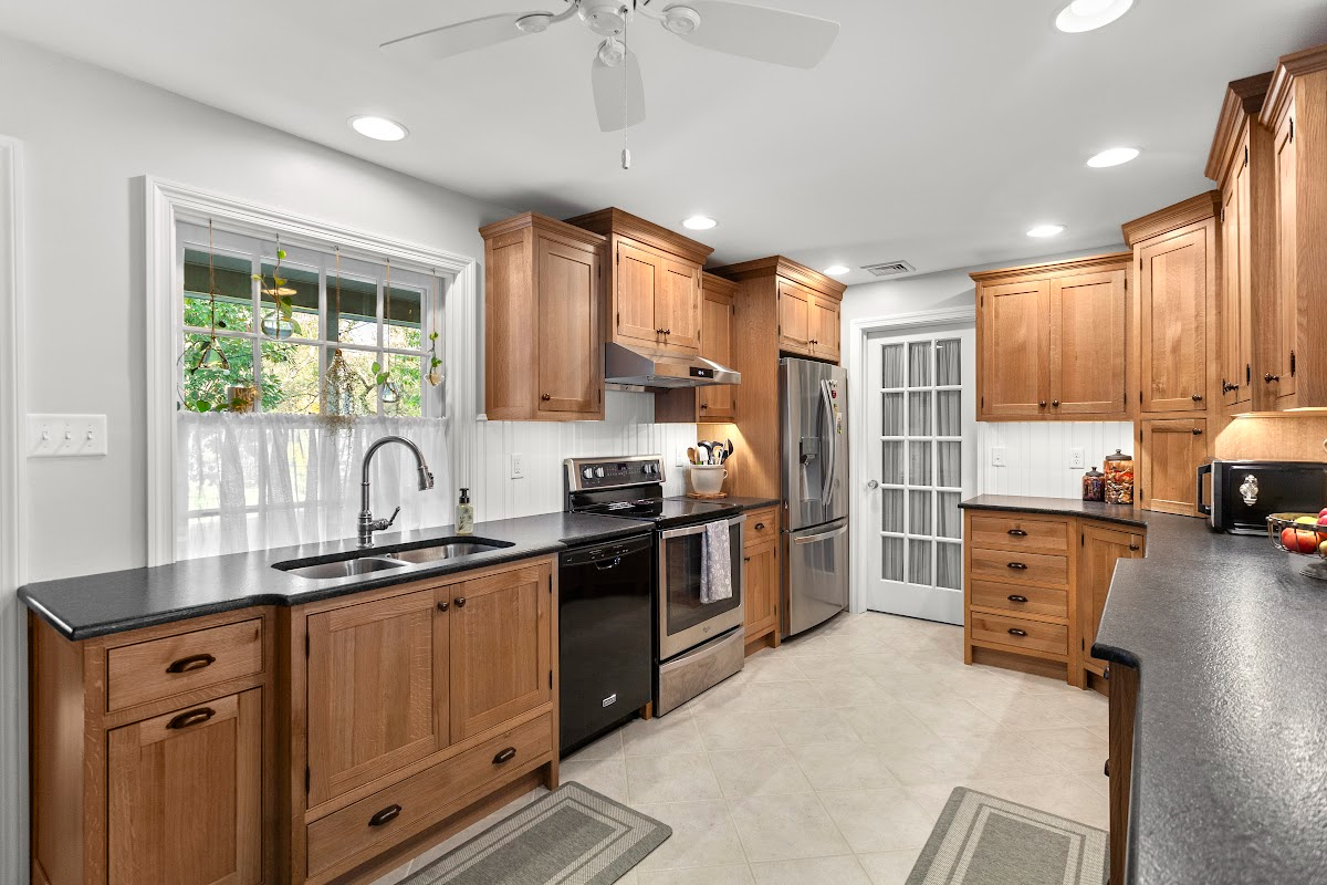 Stained cabinets in a narrow kitchen. Cabinets made with quartersawn white oak stained with Buff finish.