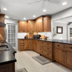 Stained cabinets in a narrow kitchen. Cabinets made with quartersawn white oak stained with Buff finish.