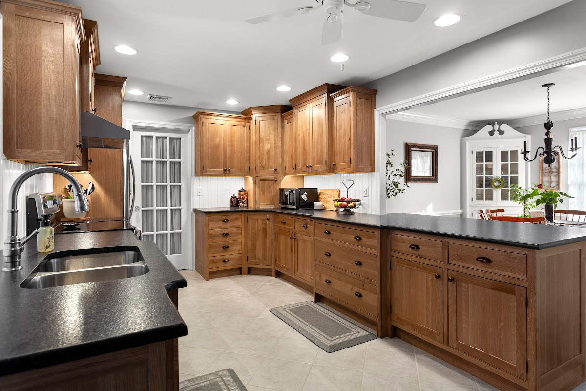 Stained cabinets in a narrow kitchen. Cabinets made with quartersawn white oak stained with Buff finish.