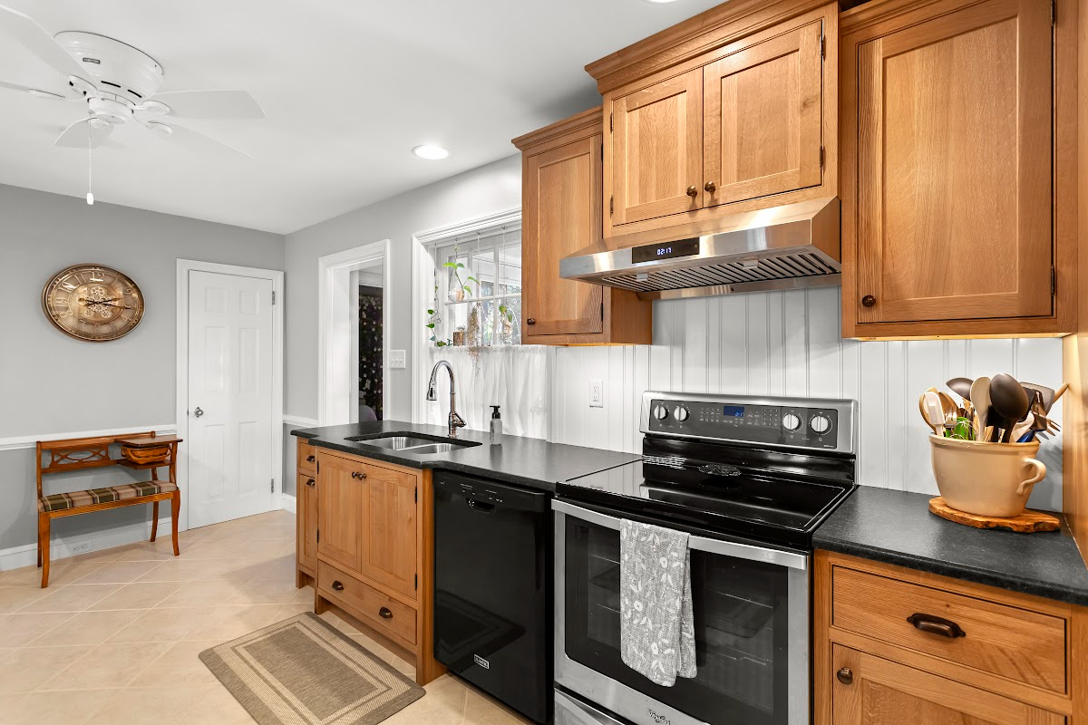 Stained cabinets in a narrow kitchen. Cabinets made with quartersawn white oak stained with Buff finish.