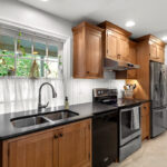 Stained cabinets in a narrow kitchen. Cabinets made with quartersawn white oak stained with Buff finish.