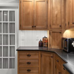 Stained cabinets in a narrow kitchen. Cabinets made with quartersawn white oak stained with Buff finish.