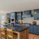 Blue painted kitchen cabinets with stained island.