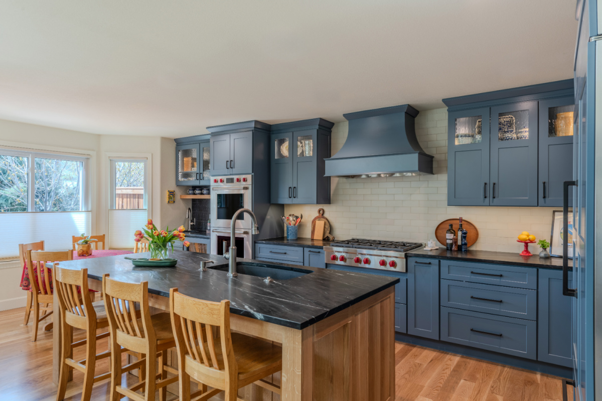 Blue painted kitchen cabinets with stained island.