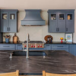 Blue painted kitchen cabinets with stained island.
