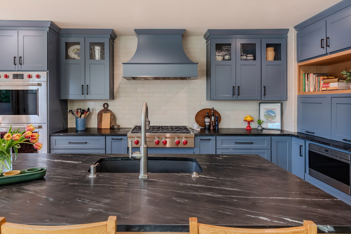 Blue painted kitchen cabinets with stained island.