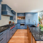 Blue painted kitchen cabinets with stained island.