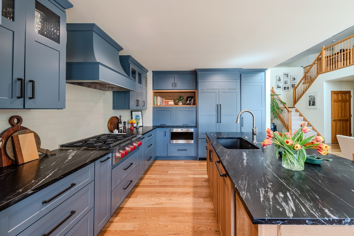 Blue painted kitchen cabinets with stained island.