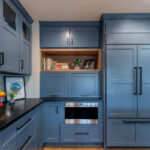 Blue painted kitchen cabinets with stained island.