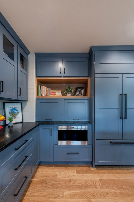 Blue painted kitchen cabinets with stained island.