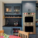 Blue painted kitchen cabinets with stained island.