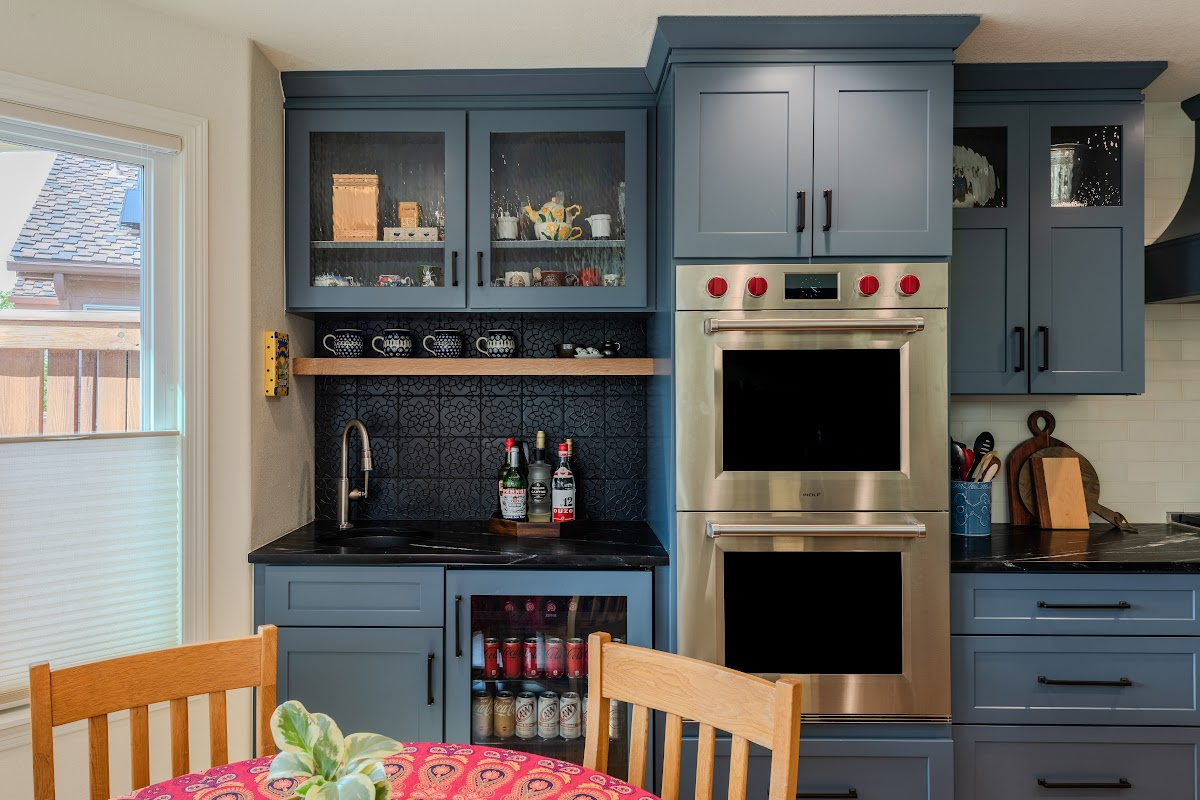 Blue painted kitchen cabinets with stained island.
