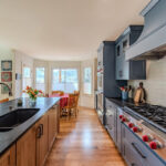 Blue painted kitchen cabinets with stained island.