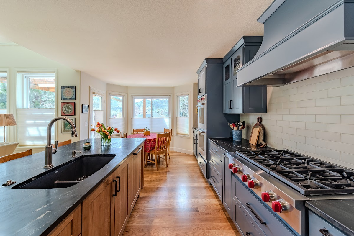Blue painted kitchen cabinets with stained island.
