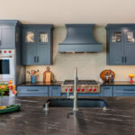 Blue painted kitchen cabinets with stained island.