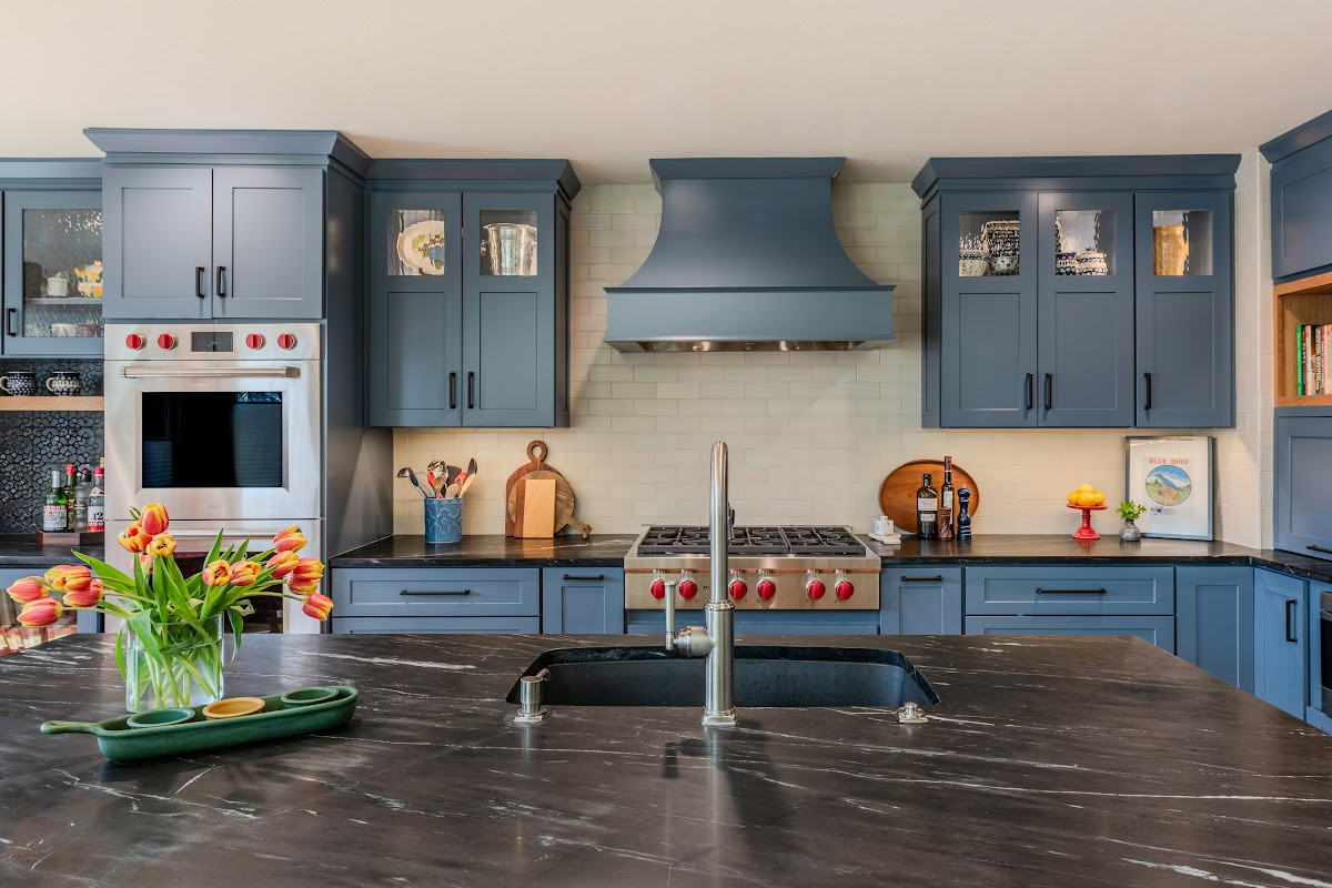Blue painted kitchen cabinets with stained island.