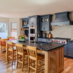 Blue painted kitchen cabinets with stained island.