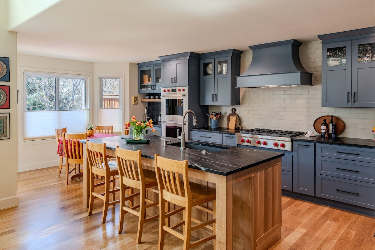 Blue painted kitchen cabinets with stained island.