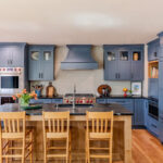 Blue painted kitchen cabinets with stained island.