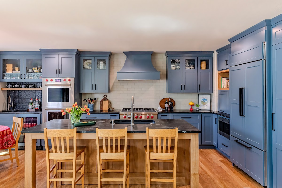 Blue painted kitchen cabinets with stained island.