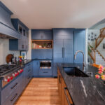 Blue painted kitchen cabinets with stained island.