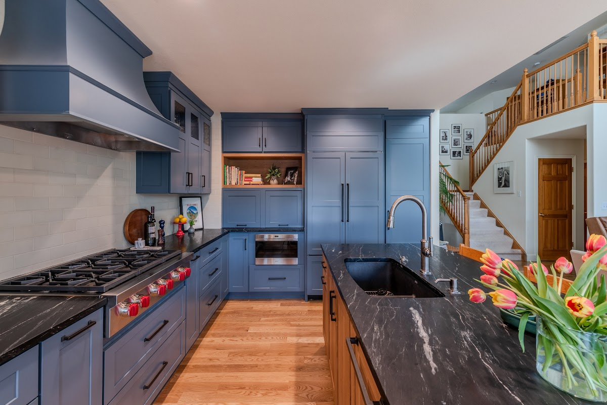 Blue painted kitchen cabinets with stained island.
