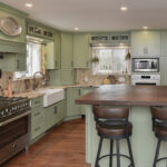 Painted kitchen cabinets in a mint green color.