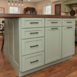 Painted kitchen cabinets in a mint green color.